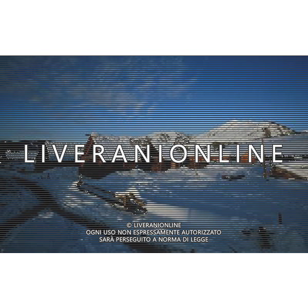 KANAS - MARCH 6: A view of the snow-covered frame houses in Hemu village at the Kanas nature reserve in Xinjiang Uygur Autonomous Region, China on Friday, March 6, 2009. Sharing borders with Kazakhstan, Russia and Mongolia, Kanas Nature Reserve boasts a beautiful natural ecosystem formed by lakes, rivers, glaciers, forests, and grasslands. Hemu Village, ranked by China National Geography as one of the six most beautiful villages in China, is one of the three residences of the Tuva Mongol in the country. The Tuva Mongol of Hemu Village lives in frame houses half-buried in the ground to resist the chillness of winter. They believe in Buddhism and have well preserved the traditional beliefs of their tribe.(Photo By Zhou You/ColorChinaPhoto) - AG. ALDO LIVERANI SAS ITALY ONLY