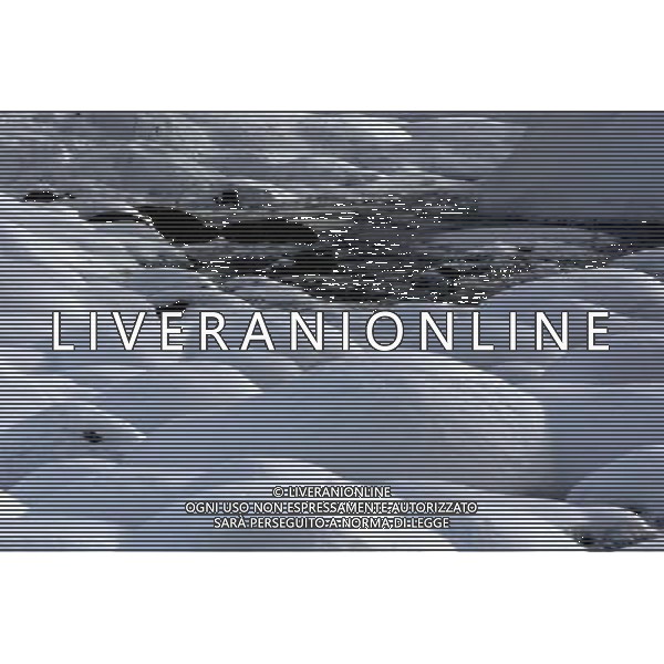 KANAS - MARCH 6: Spring flows in a snow-covered river in Hemu village at the Kanas nature reserve in Xinjiang Uygur Autonomous Region, China on Friday, March 6, 2009. Sharing borders with Kazakhstan, Russia and Mongolia, Kanas Nature Reserve boasts a beautiful natural ecosystem formed by lakes, rivers, glaciers, forests, and grasslands. Hemu Village, ranked by China National Geography as one of the six most beautiful villages in China, is one of the three residences of the Tuva Mongol in the country. The Tuva Mongol of Hemu Village lives in frame houses half-buried in the ground to resist the chillness of winter. They believe in Buddhism and have well preserved the traditional beliefs of their tribe.(Photo By Zhou You/ColorChinaPhoto) - AG. ALDO LIVERANI SAS ITALY ONLY