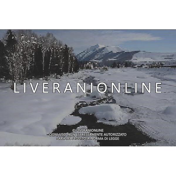 KANAS - MARCH 6: A view of the snow-covered Hemu village at the Kanas nature reserve in Xinjiang Uygur Autonomous Region, China on Friday, March 6, 2009. Sharing borders with Kazakhstan, Russia and Mongolia, Kanas Nature Reserve boasts a beautiful natural ecosystem formed by lakes, rivers, glaciers, forests, and grasslands. Hemu Village, ranked by China National Geography as one of the six most beautiful villages in China, is one of the three residences of the Tuva Mongol in the country. The Tuva Mongol of Hemu Village lives in frame houses half-buried in the ground to resist the chillness of winter. They believe in Buddhism and have well preserved the traditional beliefs of their tribe.(Photo By Zhou You/ColorChinaPhoto) - AG. ALDO LIVERANI SAS ITALY ONLY