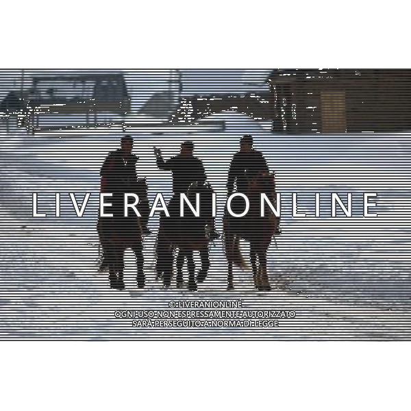 KANAS - MARCH 6: Herders ride horses past snow-covered frame houses in Hemu village at the Kanas nature reserve in Xinjiang Uygur Autonomous Region, China on Friday, March 6, 2009. Sharing borders with Kazakhstan, Russia and Mongolia, Kanas Nature Reserve boasts a beautiful natural ecosystem formed by lakes, rivers, glaciers, forests, and grasslands. Hemu Village, ranked by China National Geography as one of the six most beautiful villages in China, is one of the three residences of the Tuva Mongol in the country. The Tuva Mongol of Hemu Village lives in frame houses half-buried in the ground to resist the chillness of winter. They believe in Buddhism and have well preserved the traditional beliefs of their tribe.(Photo By Zhou You/ColorChinaPhoto) - AG. ALDO LIVERANI SAS ITALY ONLY