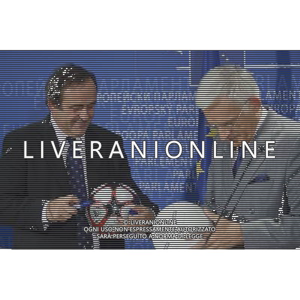 European parliament President , Polish, Jerzy Buzek and UEFA soccer organization, President Michel Platini (L) sign balls after their meeting at EU Parliament in Brussels, Belgium on 2009-11-05 Michel Platini, the head of the Union of European Football Associations, is pleading with European officials for an American-style system that restricts spending to a percentage of every soccer teams revenues. © by Wiktor Dabkowski /Agenzia Aldo Liverani Sas - ITALY ONLY -