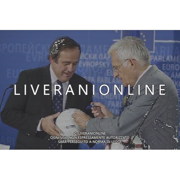 European parliament President , Polish, Jerzy Buzek and UEFA soccer organization, President Michel Platini (L) sign balls after their meeting at EU Parliament in Brussels, Belgium on 2009-11-05 Michel Platini, the head of the Union of European Football Associations, is pleading with European officials for an American-style system that restricts spending to a percentage of every soccer teams revenues. © by Wiktor Dabkowski /Agenzia Aldo Liverani Sas - ITALY ONLY -