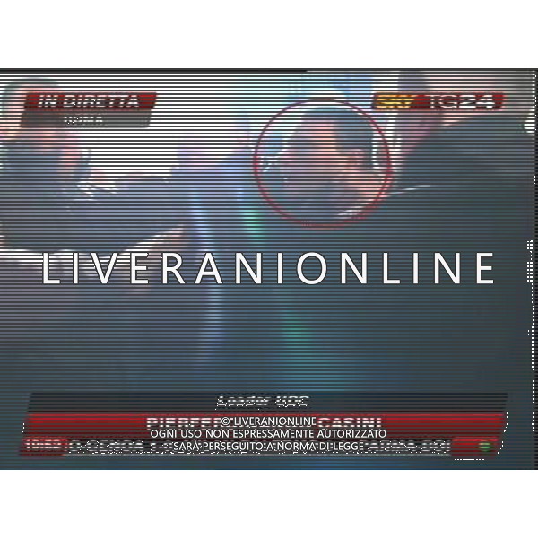 Aggressione al Presidente del Consiglio Silvio Berlusconi alla fine del suo comizio in Piazza Duomo a Milano 13/12/2009 nella foto l\'aggressore Massimo Tartaglia fermato dalle forze dell\'ordine obbligatorio citare la fonte televisiva (SkyTg24) Agenzia Aldo Liverani Sas 