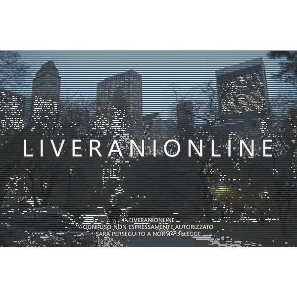 Central Park at Dusk with Manhattan Buildings in Background, New York City, 12/14/2009. People strolling. Buildings include GM Building and Plaza Hotel. Photo Credit: Dan D\'Errico - Photoshot - Ag. Aldo Liverani sas ITALY ONLY