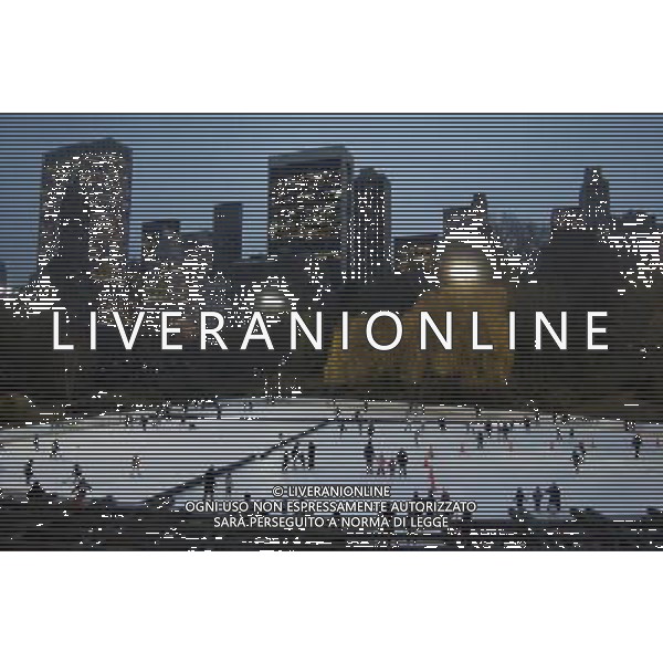 Central Park at Dusk with View of Wollman Rink ice skating and Central Park South Buildings, New York City, 12/14/2009. Buildings include GM Building and Plaza Hotel. Photo Credit: Dan D\'Errico - Photoshot - Ag. Aldo Liverani sas ITALY ONLY