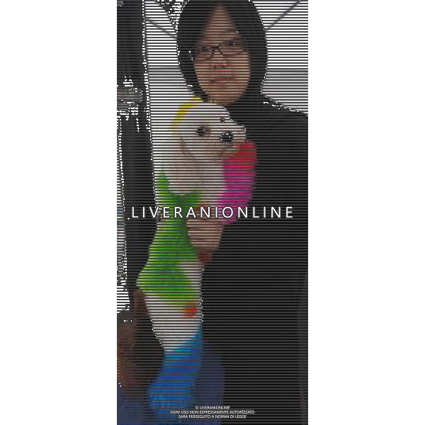 (100108) -- TAIPEI, Jan. 8, 2010 -- A participant holds her dyed dog at the annual Pet Carnival in Taipei of southeast China\'s Taiwan, Jan. 8, 2010. The three-day event, opening on Jan. 8, will include performances and contests, and promote pet-related products. Wu Ching-teng) (wqq) /Agenzia Aldo Liverani Sas - ITALY ONLY - CANE - CANI - CUCCIOLI - ANIMALI DOMESTICI