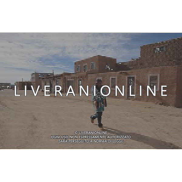 (100128) -- ALBUQUERQUE, Jan. 28, 2010 () -- A native American Indian man walks in Acoma Pueblo in New Mexico, the United States, Jan. 25, 2010. Acoma Pueblo, also known as \'Sky City\', is a Native American pueblo built on top of a 367-foot (112 meters) sandstone mesa in the U.S. state of New Mexico. It is believed to be built in the 12th century, and regarded as one of the oldest continuously inhabited communities in the United States. People are living in the adobe houses, which have no electricity and water. (/Gu Xinrong) (lyi) /Agenzia Aldo Liverani Sas - ITALY ONLY - LÕantico villaggio di Acoma, chiamata Sky City per la sua collocazione in cima ad unÕalta mesa, il tipico altipiano del Southwest. Il pueblo e\' senza acqua ed elettricita\'