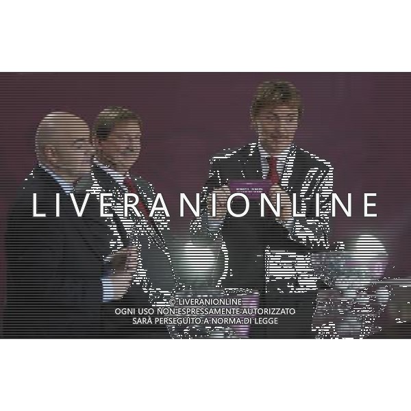 Polish former football star Zbigniew Boniek (R) draws England next UEFA general secretary Gianni Infantino (L) and Polish former football star Andrzej Szarmach (C) durnig the UEFA EURO 2012 qualifying Draw Cremony in the Congress Hall of the Palace of Culture and Science in Warsaw, Poland, 7 February 2010. 51 teams taking part in the Euro 2012 qualifications will create nine groups. Six of them will consist of six teams, and three of them – five. Winners and one team from the second place with the best achievements will advance to championships directly. The other eight teams classified on the second position in the group will set up four pairs. The EURO 2012 European soccer championship will kick off June 2012 in Poland and Ukraine. The opening match at the National Stadium in Warsaw will take place on 8 June. Eliminations will begin in September 2010 and will last until autumn 2011. /Agenzia Aldo Liverani Sas - ITALY ONLY - VARSAVIA: SORTEGGI DI QUALIFICAZIONE AGLI EUROPEI DI CALCIO UCRAINA-POLONIA 2012