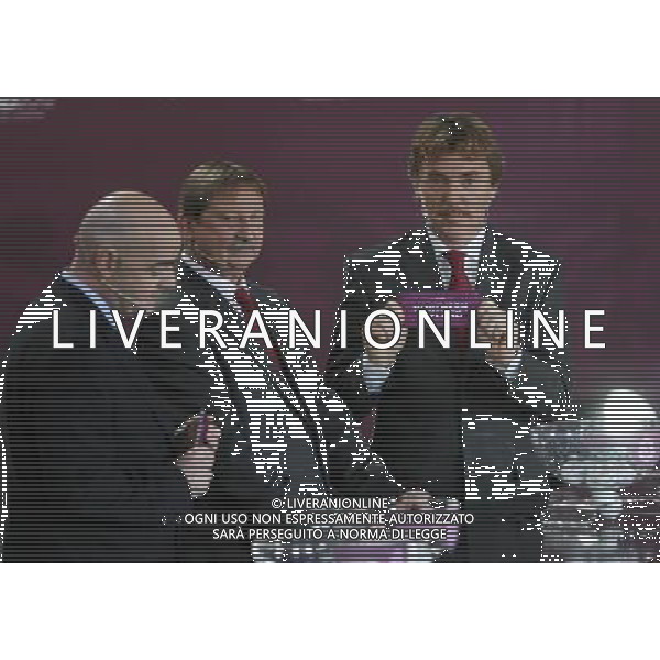Polish former football star Zbigniew Boniek (R) draws Northern Ireland next UEFA general secretary Gianni Infantino (L) and Polish former football star Andrzej Szarmach (C) durnig the UEFA EURO 2012 qualifying Draw Cremony in the Congress Hall of the Palace of Culture and Science in Warsaw, Poland, 7 February 2010. 51 teams taking part in the Euro 2012 qualifications will create nine groups. Six of them will consist of six teams, and three of them – five. Winners and one team from the second place with the best achievements will advance to championships directly. The other eight teams classified on the second position in the group will set up four pairs. The EURO 2012 European soccer championship will kick off June 2012 in Poland and Ukraine. The opening match at the National Stadium in Warsaw will take place on 8 June. Eliminations will begin in September 2010 and will last until autumn 2011. /Agenzia Aldo Liverani Sas - ITALY ONLY - VARSAVIA: SORTEGGI DI QUALIFICAZIONE AGLI EUROPEI DI CALCIO UCRAINA-POLONIA 2012