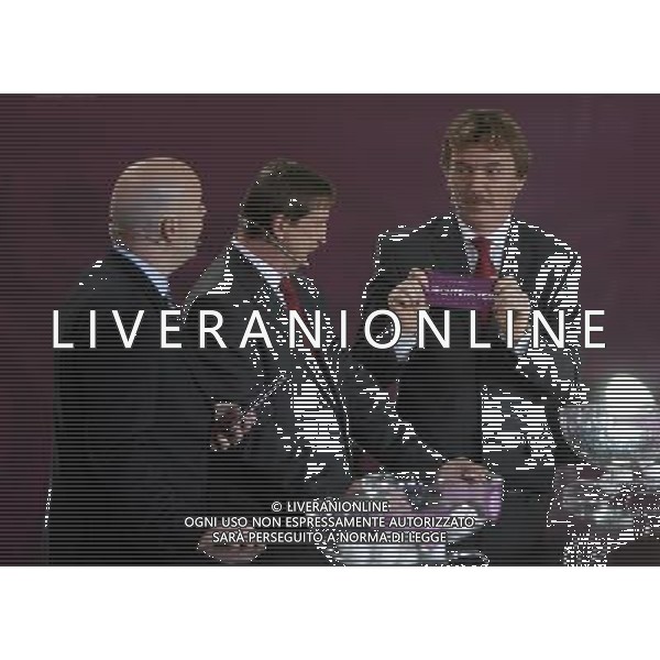 Polish former football star Zbigniew Boniek (R) draws Liechtenstein next UEFA general secretary Gianni Infantino (L) and Polish former football star Andrzej Szarmach (C) durnig the UEFA EURO 2012 qualifying Draw Cremony in the Congress Hall of the Palace of Culture and Science in Warsaw, Poland, 7 February 2010. 51 teams taking part in the Euro 2012 qualifications will create nine groups. Six of them will consist of six teams, and three of them – five. Winners and one team from the second place with the best achievements will advance to championships directly. The other eight teams classified on the second position in the group will set up four pairs. The EURO 2012 European soccer championship will kick off June 2012 in Poland and Ukraine. The opening match at the National Stadium in Warsaw will take place on 8 June. Eliminations will begin in September 2010 and will last until autumn 2011. /Agenzia Aldo Liverani Sas - ITALY ONLY - VARSAVIA: SORTEGGI DI QUALIFICAZIONE AGLI EUROPEI DI CALCIO UCRAINA-POLONIA 2012