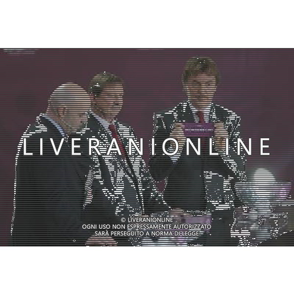 Polish former football star Zbigniew Boniek (R) draws Montenegro next UEFA general secretary Gianni Infantino (L) and Polish former football star Andrzej Szarmach (C) durnig the UEFA EURO 2012 qualifying Draw Cremony in the Congress Hall of the Palace of Culture and Science in Warsaw, Poland, 7 February 2010. 51 teams taking part in the Euro 2012 qualifications will create nine groups. Six of them will consist of six teams, and three of them – five. Winners and one team from the second place with the best achievements will advance to championships directly. The other eight teams classified on the second position in the group will set up four pairs. The EURO 2012 European soccer championship will kick off June 2012 in Poland and Ukraine. The opening match at the National Stadium in Warsaw will take place on 8 June. Eliminations will begin in September 2010 and will last until autumn 2011. /Agenzia Aldo Liverani Sas - ITALY ONLY - VARSAVIA: SORTEGGI DI QUALIFICAZIONE AGLI EUROPEI DI CALCIO UCRAINA-POLONIA 2012