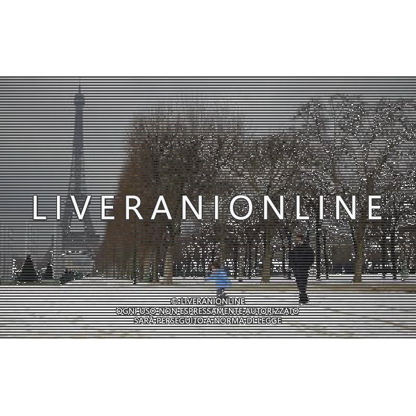 (100211) -- PARIS, Feb. 11, 2010 () -- A father and his son play on the snow-covered ground near the Eiffel Tower in Paris, capital of France, on Feb. 10, 2010. The traffic in France was severely affected by the snow hitting here on Wednesday. (/Zhang Yuwei) (wjd) /Agenzia Aldo Liverani Sas - ITALY ONLY - PARIGI: LA TORRE EIFFEL SOTTO LA NEVE - NEVICATA