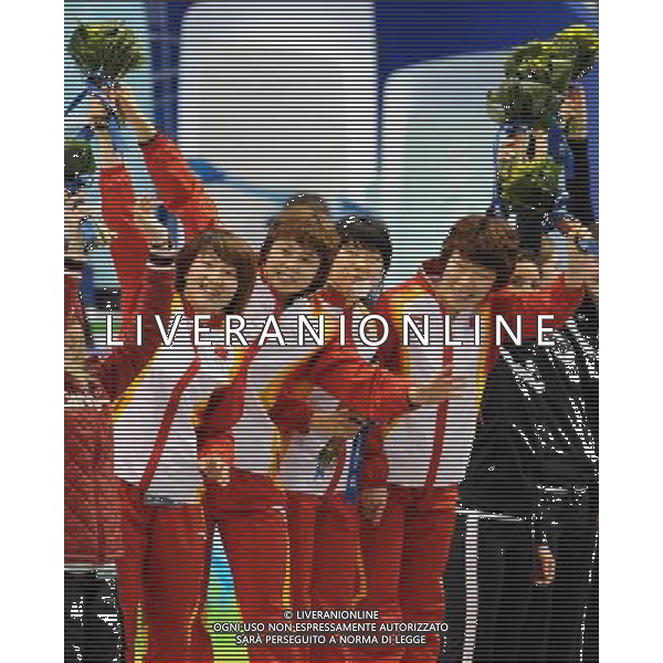 (100224) -- VANCOUVER, Feb. 24, 2010 () -- China\'s Sun Linlin, Wang Meng, Zhang Hui and Zhou Yang (L-R) react on the podium during the flower ceremony for the women\'s 3000m relay final of short track speed skating at the 2010 Winter Olympic Games in Vancouver, Canada, Feb. 24, 2010. China\'s team won the title of the event with a world-record-breaking time 4:06.610. South Korea\'s team was disqualified. (/Yang Lei) /Agenzia Aldo Liverani Sas - ITALY ONLY - CANADA: 21mi GIOCHI OLIMPICI INVERNALI OLIMPIADI DI VANCOUVER 2010