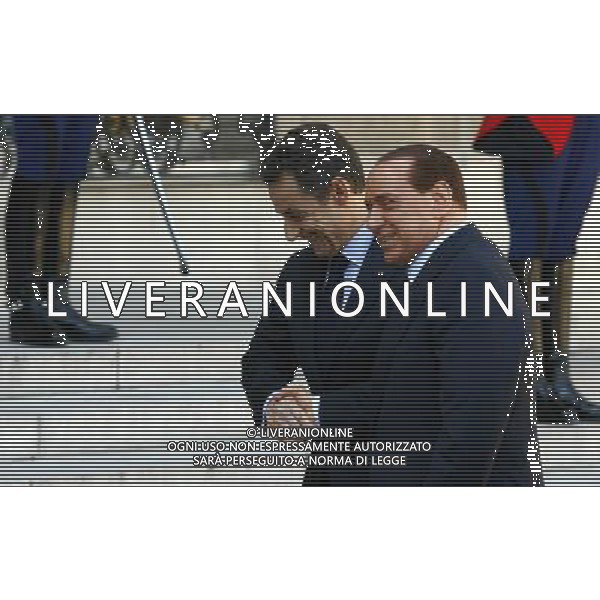 (100410) -- PARIS, April 10, 2010 -- French President Nicolas Sarkozy (L) receives Italian Prime Minister Silvio Berlusconi before the France-Italy Summit at the Elysee Palace, Paris, capital of France, April 9, 2010. The two leaders presided the signing of 20 agreements, letter of intents and joint declarations on Friday. Zhang Yuwei) (msq) /Agenzia Aldo Liverani Sas - ITALY ONLY -