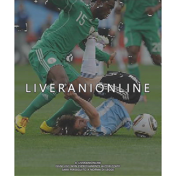 (100612) -- JOHANNESBURG, June 12, 2010 () -- Lionel Messi of Argentina (below) falls on the ground during their group B first round match against Nigeria at the 2010 FIFA World Cup at Ellis Park stadium in Johannesburg, South Africa, on June 12, 2010. (/Wang Yuguo) (xm) ©Photoshot/Agenzia Aldo Liverani Sas - ITALY ONLY - ARGENTINA- USA FIFA WORLD CUP CAMPIONATI MONDIALI SUD AFRICA 2010