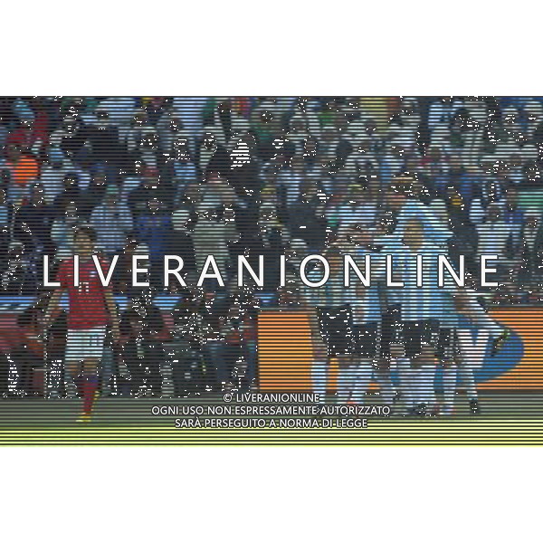 (100617) -- JOHANNESBURG, June 17, 2010 -- Argentina\'s palyers celebrate while Lee Chung-Yong of South Korea walks past during a 2010 World Cup Group B match between Argentina and South Korea at the Soccer City stadium in Soweto, suburban Johannesburg, South Africa, on June 17, 2010. Guo Yong) (ljq) ©Photoshot/Agenzia Aldo Liverani Sas - ITALY ONLY - ARGENTINA - COREA DEL SUD FIFA WORLD CUP CAMPIONATI MONDIALI SUD AFRICA 2010