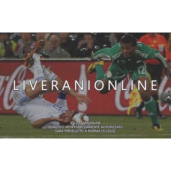 (100617) -- BLOEMFONTEIN, June 17, 2010 -- Greece\'s Giorgias Karagounis (L) falls down as he vies with Nigeria\'s Kalu Uche during a 2010 World Cup Group B match between Greece and Nigeria at the Free State Stadium in Bloemfontein, South Africa, on June 17, 2010. Greece beat Nigeria 2-1. Xu Suhui) (zc) ©Photoshot/Agenzia Aldo Liverani Sas - ITALY ONLY - GRECIA - NIGERIA FIFA WORLD CUP CAMPIONATI MONDIALI SUD AFRICA 2010