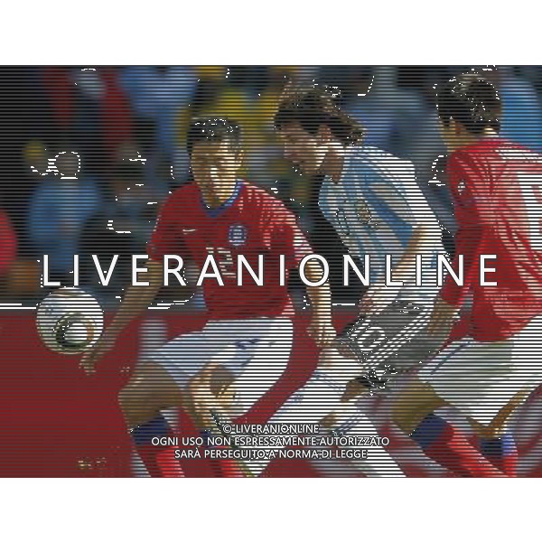 Argentina\'s Lionel Messi (C) is challenged by South Korea\'s Lee Young Pyo (L) and Kim Jung Woo (R) during the World Cup group B soccer match between Argentina and South Korea at Soccer City in Johannesburg, South Africa, Thursday, June 17, 2010. Argentina defeated South Korea 4-1.(Photo By Wei Zheng/ColorChinaPhoto) - Ag. Aldo Liverani sas ITALY ONLY ITALY ONLY: ARGENTINA - COREA DEL SUD FIFA WORLD CUP CAMPIONATI MONDIALI SUD AFRICA 2010