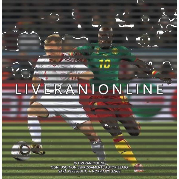 (100620) -- TSHWANE, June 20, 2010 () --Achille Emana of Cameroon(R) vies with Lars Jacobsen of Denmark during their 2010 World Cup Group E soccer match at Loftus Verfeld stadium in Tshwane, South Africa, on June 19, 2010. (/Yang Lei)(fym) ©Photoshot/Agenzia Aldo Liverani Sas - ITALY ONLY: CAMERUN - DANIMARCA FIFA WORLD CUP CAMPIONATI MONDIALI SUD AFRICA 2010