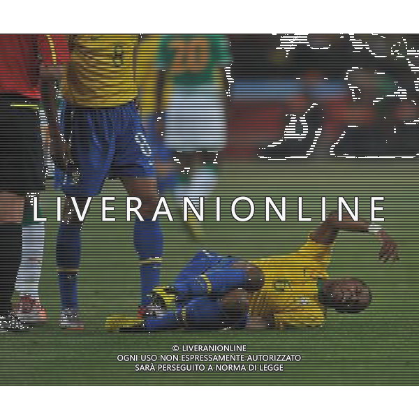 (100621) -- JOHANNESBURG, June 21, 2010 () -- Michel Bastos of Brazil (bottom) lies on the ground during the Group G soccer match against Ivory Coast at 2010 FIFA World Cup at Soccer City stadium in Johannesburg, South Africa, on June 20, 2010. Brazil won 3-1. (/Yang Lei)(xm) ©Photoshot/Agenzia Aldo Liverani Sas - ITALY ONLY: BRASILE - COSTA D\'AVORIO FIFA WORLD CUP CAMPIONATI MONDIALI SUD AFRICA 2010