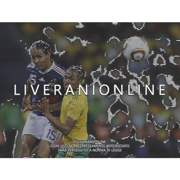 (100622) -- BLOEMFONTEIN, June 22, 2010 -- South Africa\'s Siphiwe Tshabalala (R) fights for the ball with France\'s Florent Malouda during the Group A match between France and South Africa at the 2010 World Cup football match in Bloemfontein, South Africa, on June 22, 2010. South Africa won 2-1. Chen Haitong) (zc)