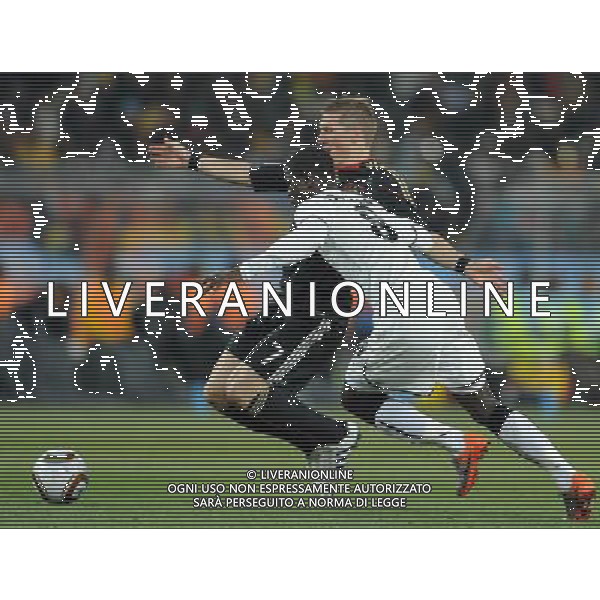 (100624) -- JOHANNESBURG, June 24, 2010 () -- Germany\'s Bastian Schweinsteiger (back) vies with Ghana\'s Jonathan Mensah during the 2010 World Cup Group D match in Johannesburg, South Africa, June 23, 2010. Germany won the match 1-0. Both Germany and Ghana are qualified for the round of 16. (/Li Ga) ©Photoshot/Agenzia Aldo Liverani Sas - ITALY ONLY: GERMANIA - GHANA FIFA WORLD CUP CAMPIONATI MONDIALI SUD AFRICA 2010