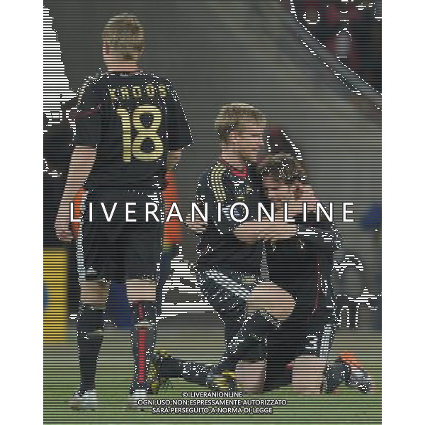 (100624) -- JOHANNESBURG, June 24, 2010 () -- Germany\'s Arne Friedrich and Per Mertesacker hug each other after the 2010 World Cup Group D match between Germany and Ghana in Johannesburg, South Africa, June 23, 2010. Germany won the match 1-0. Both Germany and Ghana are qualified for the round of 16. (/Li Ga) ©Photoshot/Agenzia Aldo Liverani Sas - ITALY ONLY: GERMANIA - GHANA FIFA WORLD CUP CAMPIONATI MONDIALI SUD AFRICA 2010