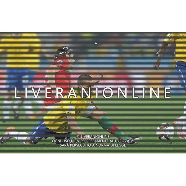 (100626) -- DURBAN, June 26, 2010 -- Brazil\'s Dani Alves (front) falls on the pitch during the Group G last round match against Portugal at 2010 FIFA World Cup, at Moses Mabhida stadium in Durban, South Africa, on June 25, 2010. The match tied 0-0. Both Brazil and Portugal are qualified for the round of 16. Chen Haitong) (dl) MONDIALI DI CALCIO SUDAFRICA 2010 PORTOGALLO BRASILE CALCIO SPORT ©PHOTOSHOT/ALDO LIVERANI ITALY ONLY