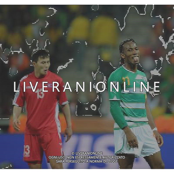 (100626) -- NELSPRUIT, June 26, 2010 -- Didier Drogba (R) of Cote d\'Ivoire reacts during the Group G last round match against Democratic People\'s Republic of Korea (DPRK) at 2010 FIFA World Cup, at Mbombela Stadium in Nelspruit, South Africa, on June 25, 2010. Cote d\'Ivoire won 3-0 and both teams failed to progress to the next round. Wang Yuguo)(fym) COSTA D\'AVORIO COREA DEL NORD FIFA WORLD CUP 2010 SUDAFRICA CALCIO SPORT ©PHOTOSHOT/ALDO LIVERANI ITALY ONLY