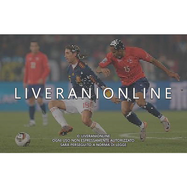 (100626) -- TSHWANE, June 26, 2010 -- Sergio Ramos (Front) of Spain vies with Jean Beausejour of Chile during the Group H last round match at 2010 FIFA World Cup, at Loftus Verfeld stadium in Tshwane, South Africa, on June 25, 2010. Spain won 2-1 and both teams are qualified for the next round. Li Ga) (fym) PHOTOSHOT-AG ALDO LIVERANI ONLY ITALY