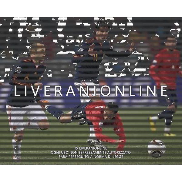 (100626) -- TSHWANE, June 26, 2010 -- Fabian Orellana (bottom) of Chile falls on the pitch during the Group H last round match against Spain at 2010 FIFA World Cup, at Loftus Verfeld stadium in Tshwane, South Africa, on June 25, 2010. Spain won 2-1 and both teams are qualified for the next round. Xing Guangli) (fym) PHOTOSHOT-AG ALDO LIVERANI ONLY ITALY