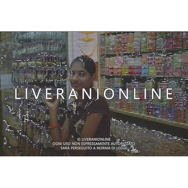 (100813) -- SINGAPORE, Aug. 13, 2010 () -- An Indian woman waits for customers at a jewelry store in Little India district, Singapore, Aug. 12, 2010. Little India, as the name promises, is the center for the large Indian community in Singapore. Indian temples, colorful sarees, jasmine garlands, as well as the smells of spice and blasts of Bollywood music make this district a distinct place to visit in Singapore. (/Cai Yang) (msq) ©photoshot/Agenzia Aldo Liverani Sas - ITALY ONLY - Il quartiere di Little India a Singapore, Little India, e\' il centro per la numerosa comunita\' indiana, templi indiani, saree colorati, ghirlande di gelsomini, cosi\' come gli odori di spezie e raffiche di musica di Bollywood fanno di questo quartiere un luogo da visitare