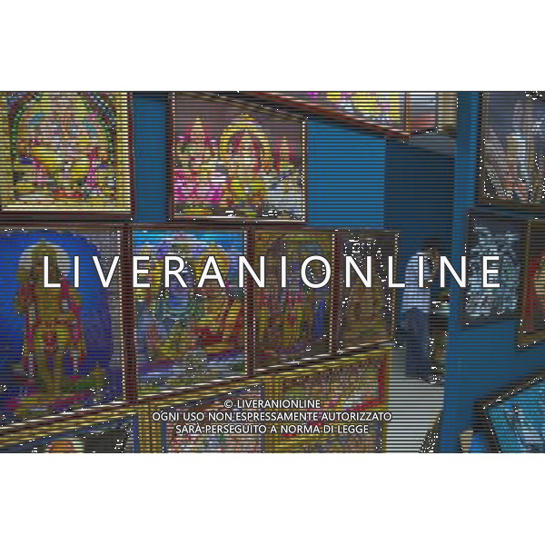 (100813) -- SINGAPORE, Aug. 13, 2010 () -- A man makes a phone call at his painting store in Little India district, Singapore, Aug. 12, 2010. Little India, as the name promises, is the center for the large Indian community in Singapore. Indian temples, colorful sarees, jasmine garlands, as well as the smells of spice and blasts of Bollywood music make this district a distinct place to visit in Singapore. (/Cai Yang) (msq) ©photoshot/Agenzia Aldo Liverani Sas - ITALY ONLY - Il quartiere di Little India a Singapore, Little India, e\' il centro per la numerosa comunita\' indiana, templi indiani, saree colorati, ghirlande di gelsomini, cosi\' come gli odori di spezie e raffiche di musica di Bollywood fanno di questo quartiere un luogo da visitare