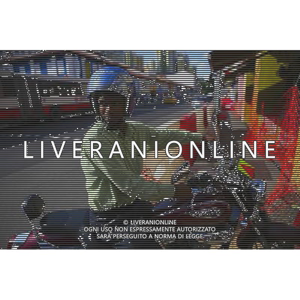 (100813) -- SINGAPORE, Aug. 13, 2010 () -- An Indian man is seen on his motorcycle in Little India district, Singapore, Aug. 12, 2010. Little India, as the name promises, is the center for the large Indian community in Singapore. Indian temples, colorful sarees, jasmine garlands, as well as the smells of spice and blasts of Bollywood music make this district a distinct place to visit in Singapore. (/Cai Yang) (msq) ©photoshot/Agenzia Aldo Liverani Sas - ITALY ONLY - Il quartiere di Little India a Singapore, Little India, e\' il centro per la numerosa comunita\' indiana, templi indiani, saree colorati, ghirlande di gelsomini, cosi\' come gli odori di spezie e raffiche di musica di Bollywood fanno di questo quartiere un luogo da visitare