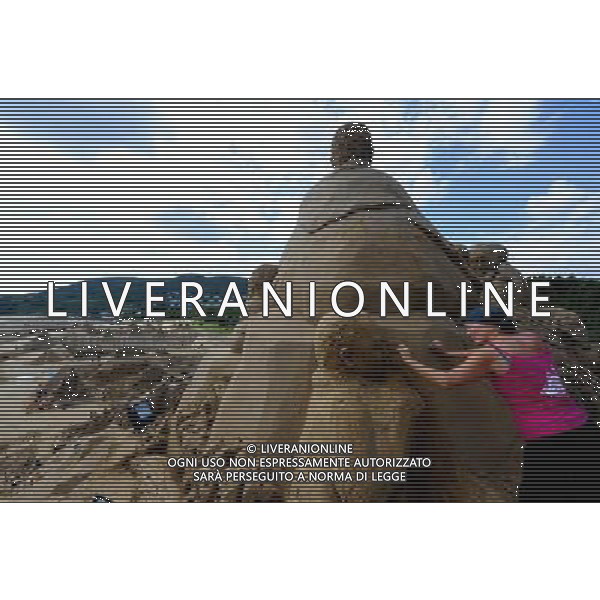 ZHOUSHAN, Sept. 24, 2010 - Dutch artist Marjon Katerberg carves on a sand sculpture in Zhoushan, east China\'s Zhejiang Province, on Sept. 24, 2010. More than 30 artists from home and abroad exhibit their talents, on the theme of a trip to Africa, during a sand sculpture festival here from the 12th to 29th of September, 2010. A 20.91-meter tall sculpture, featuring a Nigerian tale on how a hummingbird become the king of all animals, was competing for the title of World\'s tallest sand sculpture. (/Xu Yu) (lb) © Xu Yu - Xinhua - Photoshot - Ag. Aldo Liverani sas ITALY ONLY CINA - FESTIVAL DELLE SCULTURE DI SABBIA: VIAGGIO IN AFRICA