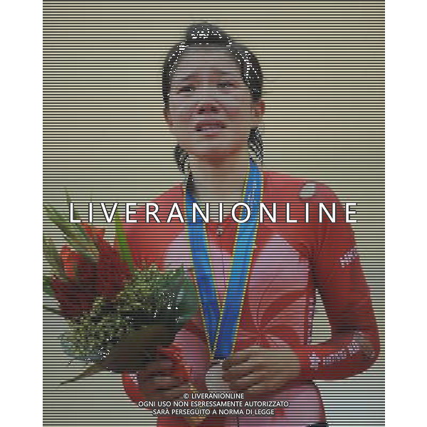 (101116) -- GUANGZHOU, Nov. 16, 2010 () -- Wong Wan Yiu of Hong Kong of China sheds tears during the awarding ceremony for the women\'s cycling Points Race finals at the 16th Asian Games in Guangzhou, south China\'s Guangdong Province, Nov. 16, 2010. Wong Wan Yiu won the silver medal with 27 points. (/Li Ga) ©photoshot/Agenzia Aldo Liverani Sas - ITALY ONLY - 16a Giochi Asiatici di Guangzhou, nel sud della Cina