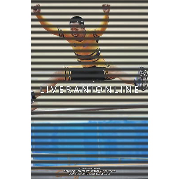 (101117) -- GUANGZHOU, Nov. 17 () -- Silver medalist Josiah Ng of Malaysia jumps onto the podium during the awarding ceremony for the men\'s Keirin final of Cycling Track competition at the 16th Asian Games in Guangzhou, south China\'s Guangdong Province, Nov. 17, 2010. (/Li Ga) ©PHOTOSHOT /Agenzia Aldo Liverani Sas - ITALY ONLY - CINA: 16mi Giochi Asiatici di Guangzhou