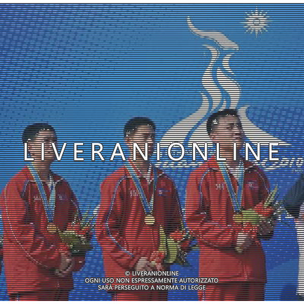 (101117) -- GUANGZHOU, Nov. 17() -- Gold medalists Jo Yong Chol, Kim Ju Song and Pak Myong Won (from L to R) of DPRK listen to the national anthem during the awarding ceremony for the men\'s 10m Running Target Mixed Team at the 16th Asian Games in Guangzhou, south China\'s Guangdong Province, Nov. 17, 2010. (/Chen Yehua) ©PHOTOSHOT /Agenzia Aldo Liverani Sas - ITALY ONLY - CINA: 16mi Giochi Asiatici di Guangzhou