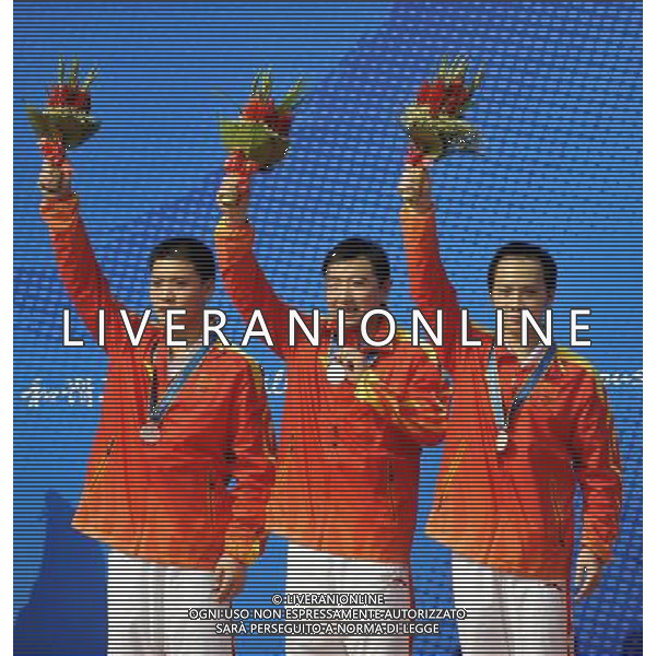 (101117) -- GUANGZHOU, Nov. 17() -- Silver medalists Zhai Yujia, Yang Ling and Gan Lin (from L to R) of China pose on the podium during the awarding ceremony for the men\'s 10m Running Target Mixed Team at the 16th Asian Games in Guangzhou, south China\'s Guangdong Province, Nov. 17, 2010. China took the silver with 1135 points. (/Chen Yehua) ©PHOTOSHOT /Agenzia Aldo Liverani Sas - ITALY ONLY - CINA: 16mi Giochi Asiatici di Guangzhou
