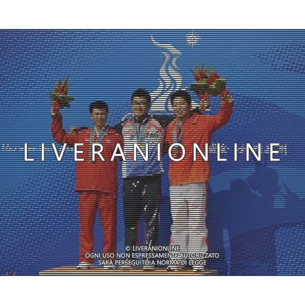 (101117) -- GUANGZHOU, Nov. 17() -- Gold medalist Hong Seonghwan (C) of South Korea, silver medalist Kim Jong Su (L) of Democratic People\'s Republic of Korea (DPRK) and bronze medalist Yin Yongde of China pose on the podium during the awarding ceremony for the men\'s 25m Standard Pistol at the 16th Asian Games in Guangzhou, south China\'s Guangdong Province, Nov. 17, 2010. (/Chen Yehua) ©PHOTOSHOT /Agenzia Aldo Liverani Sas - ITALY ONLY - CINA: 16mi Giochi Asiatici di Guangzhou