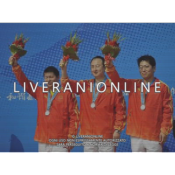 (101117) -- GUANGZHOU, Nov. 17() -- Team China pose on the podium during the awarding ceremony for the men\'s 25m Standard Pistol team at the 16th Asian Games in Guangzhou, south China\'s Guangdong Province, Nov. 17, 2010. China took the silver with 1707 points. (/Chen Yehua) ©PHOTOSHOT /Agenzia Aldo Liverani Sas - ITALY ONLY - CINA: 16mi Giochi Asiatici di Guangzhou