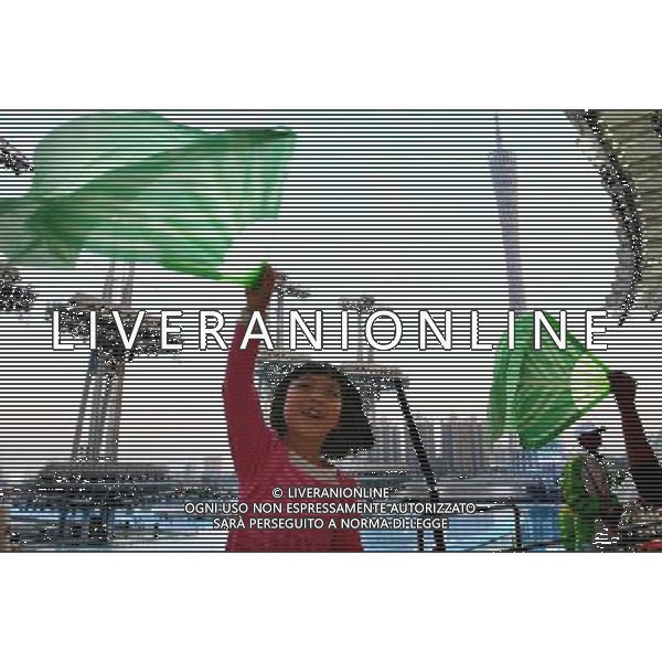 A child waves a green fan as she waits for the Asian Games opening ceremony on the Haixinsha Island in Guangzhou in south China\'s Guangdong province on Friday, Nov. 12, 2010.(Photo By Fu Tian/ColorChinaPhoto) - AG. ALDO LIVERANI SAS ITALY ONLY CINA - GIOCHI ASIATICI DI GUANGZHOU 2010