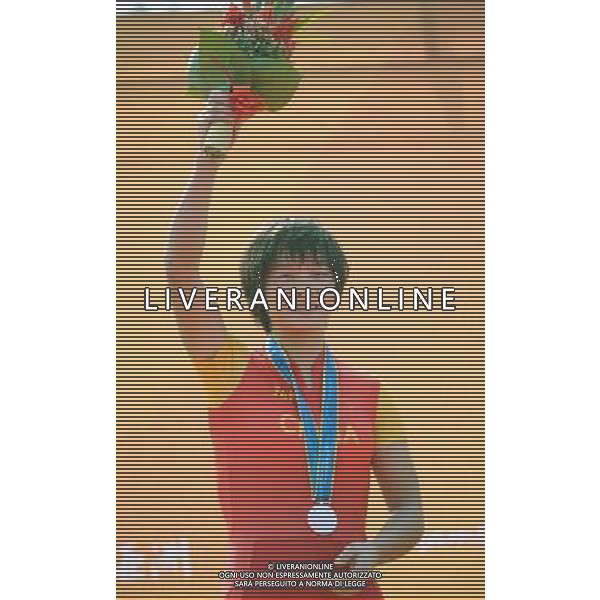 (101118) -- GUANGZHOU, Nov. 18, 2010 () -- Silver medallist Shi Qinglan of China celebrates on the podium during the awarding ceremony for the women\'s cross-country cycling event at the 16th Asian Games near Guangzhou, south China\'s Guangdong Province, Nov. 18, 2010. Shi Qinglan took the second place in a time of 1 hour, 53 minutes and 7.99 seconds. (/Li Ga) ©photoshot/Agenzia Aldo Liverani Sas - ITALY ONLY - CINA: 16mi Giochi Asiatici di Guangzhou