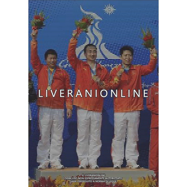 (101118) -- GUANGZHOU, Nov. 18, 2010 () -- (From L to R) Gold medalists Li Chuanlin, Liu Yadong and Jin Yongde of China celebrate during the awarding ceremony for the men\'s 25m center fire pistol team event of shooting at the 16th Asian Games in Guangzhou, south China\'s Guangdong Province, Nov. 18, 2010. (/Chen Yehua) ©photoshot/Agenzia Aldo Liverani Sas - ITALY ONLY - CINA: 16mi Giochi Asiatici di Guangzhou