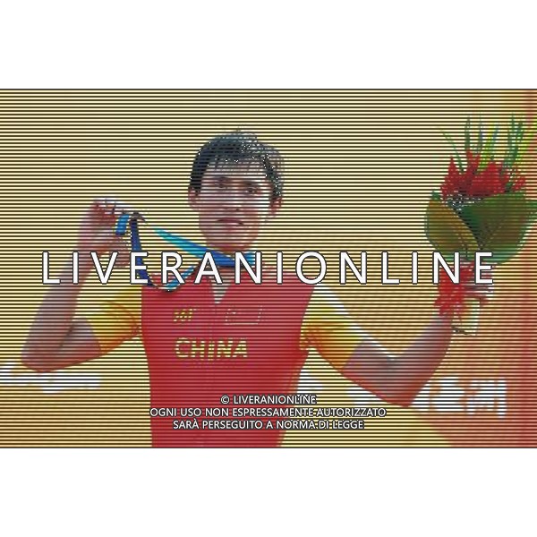 (101118) -- GUANGZHOU, Nov. 18, 2010 () -- Bronze medalist China\'s Duan Zhiqiang celebrates during the awarding ceremony for the men\'s cross-country cycling event at the 16th Asian Games near Guangzhou, south China\'s Guangdong Province, Nov. 18, 2010. (/Li Ga) ©photoshot/Agenzia Aldo Liverani Sas - ITALY ONLY - CINA: 16mi Giochi Asiatici di Guangzhou