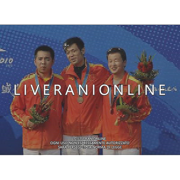 (101118) -- GUANGZHOU, Nov. 18() -- Bronze medalists Cao Yifei, Zhu Qinan and Li Bo (left to right) of China pose on the podium during the awarding ceremony for the men\'s 50m Rifle 3 Positions Team Match at the 16th Asian Games in Guangzhou, south China\'s Guangdong Province, Nov. 18, 2010. China won the bronze medal with total score of 3471 points.(/Chen Yehua) ©photoshot/Agenzia Aldo Liverani Sas - ITALY ONLY - CINA: 16mi Giochi Asiatici di Guangzhou