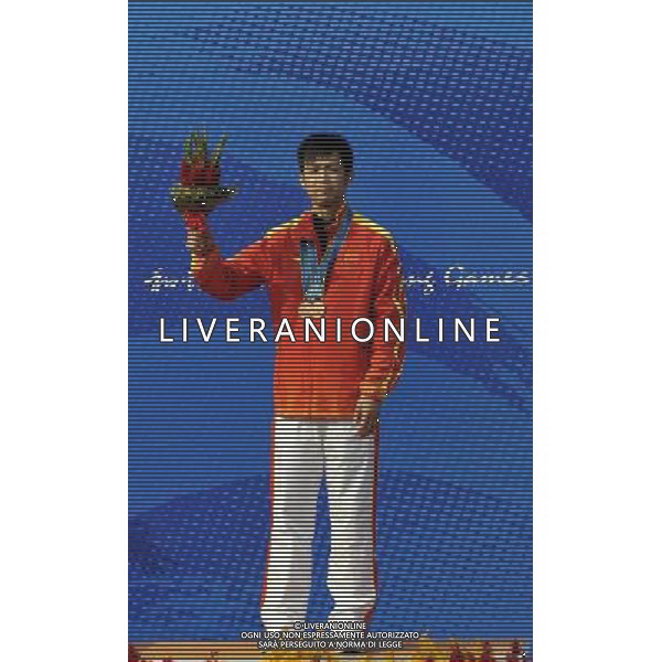 (101118) -- GUANGZHOU, Nov. 18() -- Bronze medalist Zhu Qinan of China poses on the podium during the awarding ceremony for the men\'s 50m Rifle 3 Positions match at the 16th Asian Games in Guangzhou, south China\'s Guangdong Province, Nov. 18, 2010. (/Chen Yehua) ©photoshot/Agenzia Aldo Liverani Sas - ITALY ONLY - CINA: 16mi Giochi Asiatici di Guangzhou