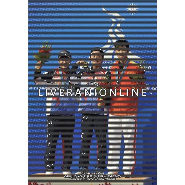 (101118) -- GUANGZHOU, Nov. 18() -- Gold medalist Han Jinweop (C) of South Korea, silver medalist Kim Jonghyun of South Korea (L) and bronze medalist Zhu Qinan of China pose on the podium during the awarding ceremony for the men\'s 50m Rifle 3 Positions match at the 16th Asian Games in Guangzhou, south China\'s Guangdong Province, Nov. 18, 2010. (/Chen Yehua) ©photoshot/Agenzia Aldo Liverani Sas - ITALY ONLY - CINA: 16mi Giochi Asiatici di Guangzhou