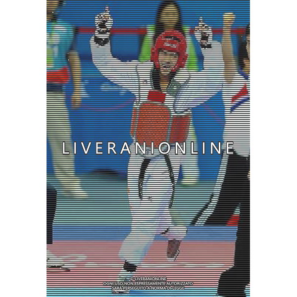 (101120) -- GUANGZHOU, Nov. 20, 2010 () -- Chutchawal Khawlaor of Thailand celebrates after the final of men\'s under 54kg of taekwondo against Kim Seong Ho of South Korea at the 16th Asian Games in Guangzhou, south China\'s Guangdong Province, Nov. 20, 2010. Chutchawal Khawlaor claimed the title with 8-6. (/Chen Kai)(wll) ©photoshot/Agenzia Aldo Liverani Sas - ITALY ONLY - CINA: 16mi Giochi Asiatici