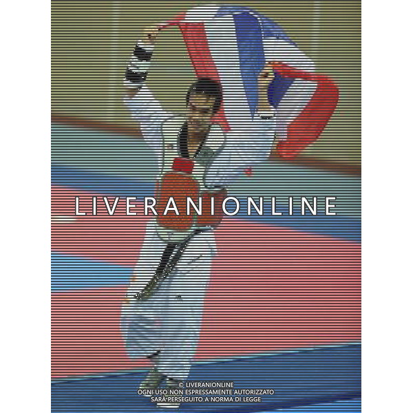 (101120) -- GUANGZHOU, Nov. 20, 2010 () -- Chutchawal Khawlaor of Thailand celebrates after the final of men\'s under 54kg of taekwondo against Kim Seong Ho of South Korea at the 16th Asian Games in Guangzhou, south China\'s Guangdong Province, Nov. 20, 2010. Chutchawal Khawlaor claimed the title with 8-6. (/Chen Kai)(wll) ©photoshot/Agenzia Aldo Liverani Sas - ITALY ONLY - CINA: 16mi Giochi Asiatici